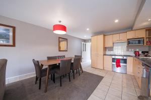 a kitchen and dining room with a table and chairs at Voyager Apartments Taupo in Taupo