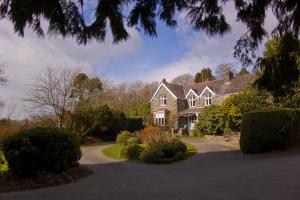 a large house with a driveway in front of it at Ty Mawr Hotel in Llanbedr