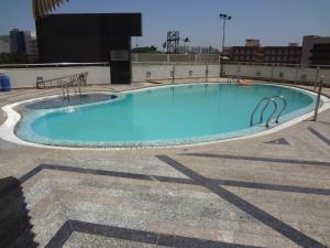 a large swimming pool on top of a building at Hotel Satkar Residency in Thane