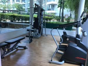 a gym with tread machines in a building at Condo at Parkside Villas across the airport in Manila