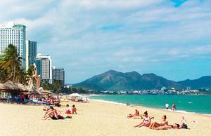 a group of people laying on a beach at New Sun Hotel in Nha Trang