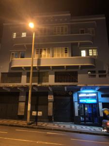 a building with a street light in front of it at Motel Coimbra (Adults only) in Belo Horizonte +8 photos