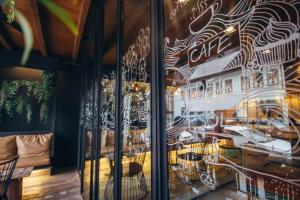a window of a restaurant with tables and chairs at Phuket Sunny Hostel in Phuket Town