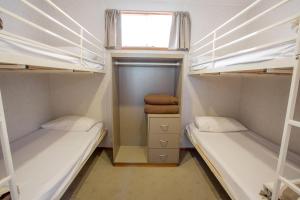 a room with two bunk beds and a window at BIG4 Shepparton Park Lane Holiday Park in Shepparton