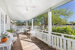 a white porch with chairs and a ceiling fan at BIRCHES B&B in Taree