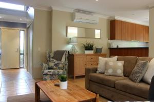 a living room with a couch and a table at Annie's Place in Cowes