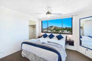 a bedroom with a large bed and a large window at Spindrift on the Beach - Absolute Beachfront in Gold Coast