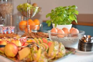einen Tisch mit Teller mit Lebensmitteln und Obst in der Unterkunft Schlafmeile Traunsee in Ebensee