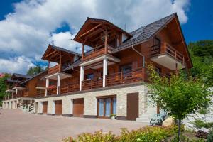 a large wooden house with balconies on it at Apartamenty Home Sweet Home Na Górnej in Szklarska Poręba