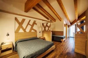 En eller flere senge i et værelse på Hotel Al Plan Andalo