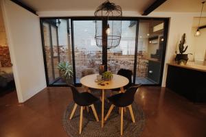 a dining room with a table and chairs at THE WAREHOUSE APARTMENTS in Geelong