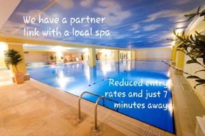 a large swimming pool with a quote on the wall at The Priory in Hereford