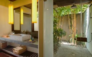a bathroom with a sink and a mirror at Jeeva Klui Resort in Senggigi