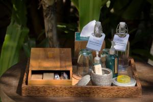 a wooden box with bottles of perfume on a table at Jeeva Klui Resort in Senggigi