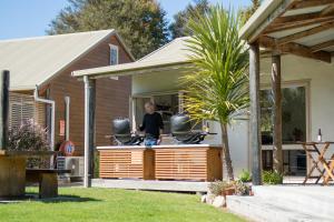 
a man on a skateboard in front of a house at Abel Tasman Lodge in Marahau
