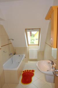 a bathroom with a tub and a sink and a bath tub at Roselio Sky Residence in Hévíz