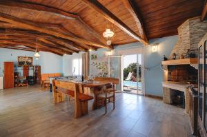 a large dining room with a table and a fireplace at Apartments Faris in Kanfanar