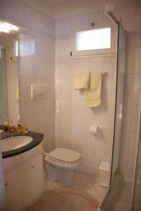 a bathroom with a toilet and a sink and a shower at Casa Fantasia in Tremezzo