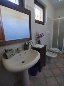 a bathroom with a white sink and a toilet at B&B A CASA DI ROSA in Caselle Torinese