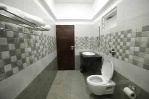 a bathroom with a toilet and a sink at Shivalaya Residency in Trichūr