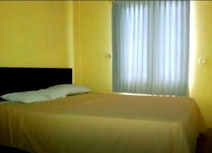 Postel nebo postele na pokoji v ubytování Syifa Homestay