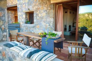 a table with a bowl of fruit on a patio at Pezoulia in Selakano