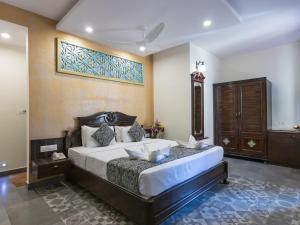 a bedroom with a large bed in a room at Resort Terra Paraiso in Calangute