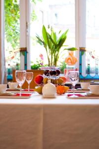 a table with wine glasses and fruit on it at B&B Lodging At 8 in Leuven