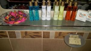 a glass table with different colored bottles and a plate of cheese at Berce Hotel Istanbul in Istanbul