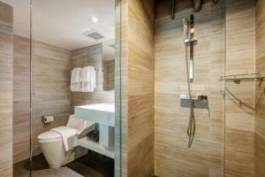 a bathroom with a shower and a toilet and a sink at Sib Kao in Bangkok