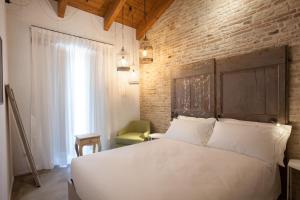 Postel nebo postele na pokoji v ubytování Terra di Gradara