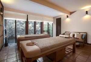 a bedroom with two beds and a window at Jeeva Klui Resort in Senggigi