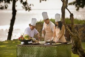 a group of chefs preparing food on a table at Jeeva Klui Resort in Senggigi