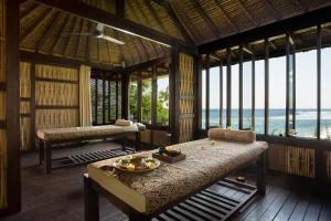 a room with a bed and a view of the ocean at Jeeva Klui Resort in Senggigi