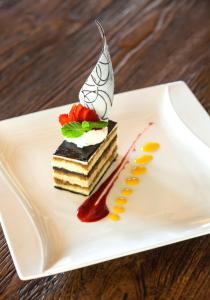 a piece of cake on a white plate on a table at Jeeva Klui Resort in Senggigi