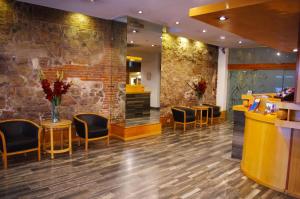 eine Bar in einer Hotellobby mit Stühlen und einer Theke in der Unterkunft Hotel Felipe II in Cordoba