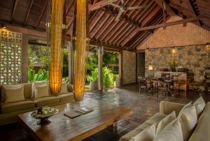 a living room with a couch and a table at Jeeva Klui Resort in Senggigi