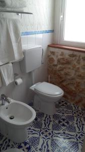 a bathroom with a toilet and a sink at Blue Bab B&B in Lampedusa