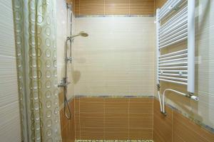 a bathroom with a shower with a glass door at Villa U Tsymbora in Sinyak