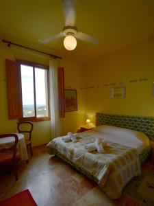 a bedroom with a bed and a ceiling fan at damario panorama in Panzano