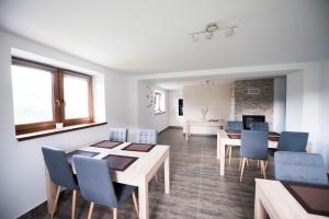 a dining room with a table and blue chairs at u Jagody in Mszana Dolna