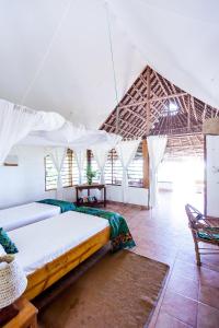 a bedroom with a bed in a tent at Capricorn Beach Cottages in Pangani