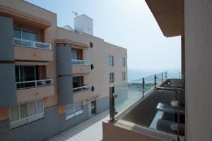a building with a view of the ocean from a balcony at Edificio Arinaga Golden in Arinaga
