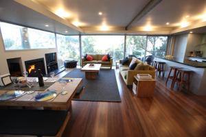 a living room filled with furniture and a fireplace at Lorne Luxury in Lorne