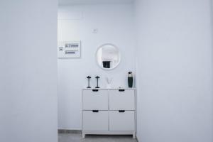 a white bathroom with a sink and a mirror at Edificio Arinaga Golden in Arinaga +62 photos