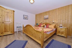 a bedroom with a large wooden bed in a room at Haus Meinecke in Bad Hindelang