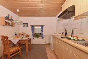 a kitchen with a table and a sink and a counter top at Haus Meinecke in Bad Hindelang