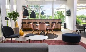 a lobby with tables and chairs and a bar at Nordic Hotel Abuja in Abuja