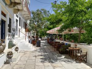 a street with tables and chairs in a town at Casa D'Aperathou II in Apeiranthos