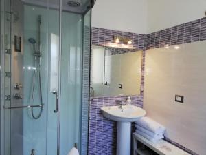 a bathroom with a sink and a shower at Akron B&B in SantʼAlessio Siculo